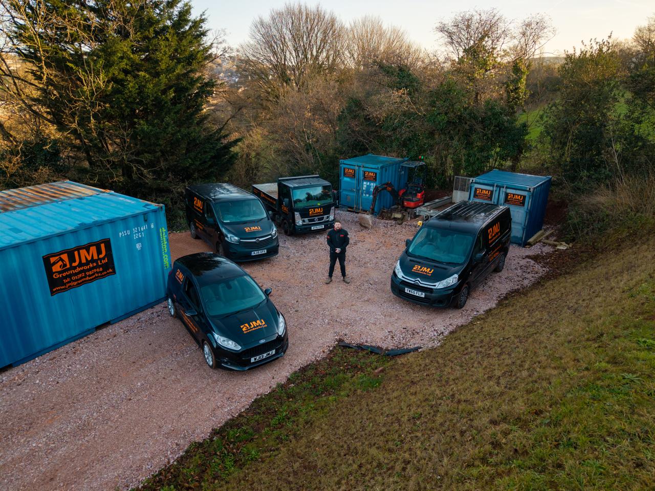 joe standing with groundworks vehicles